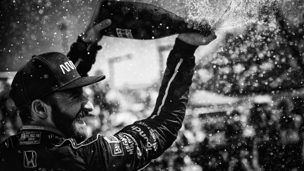 James Hinchcliffe sprays the champagne in Victory Circle after winning the Iowa Corn 300 at Iowa Speedway -- Photo by: Shawn Gritzmacher