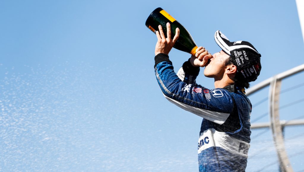 Takuma Sato drinks the champagne in Victory Circle after winning the Grand Prix of Portland at Portland International Raceway -- Photo by: Joe Skibinski