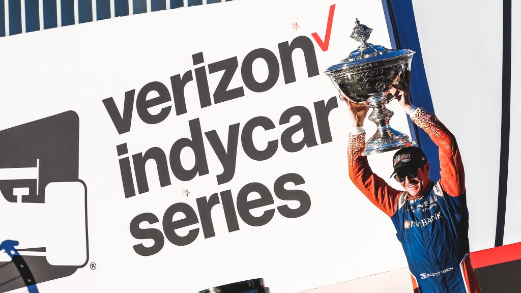 Scott Dixon hoists the Astor Cup on stage after winning the 2018 Verizon IndyCar Series championship at Sonoma Raceway -- Photo by: Joe Skibinski